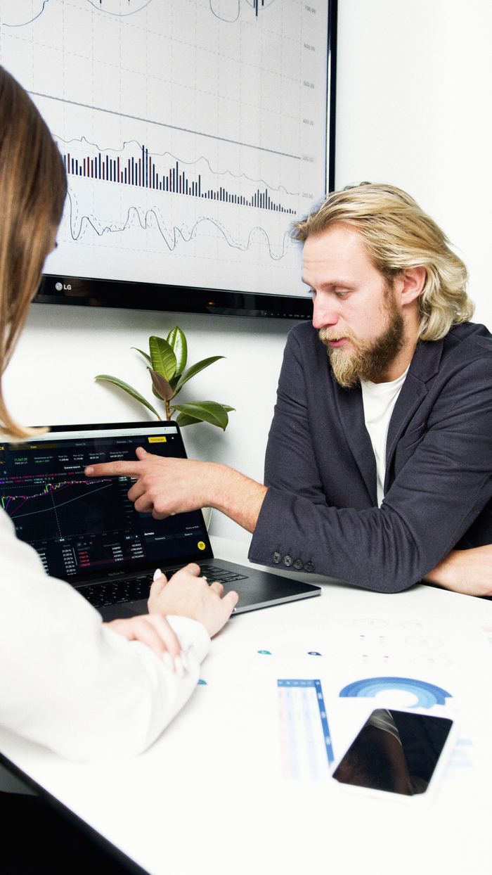 contact-img Professionals discussing financial charts and graphs during a business meeting.